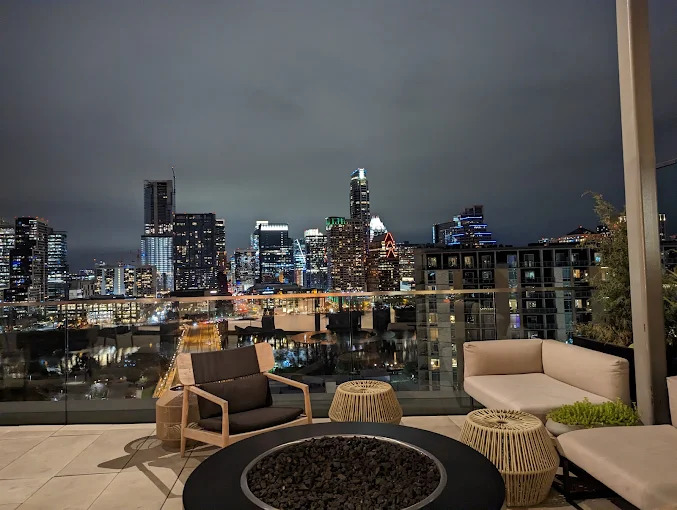 Rooftop terrace with downtown Austin skyline views at night