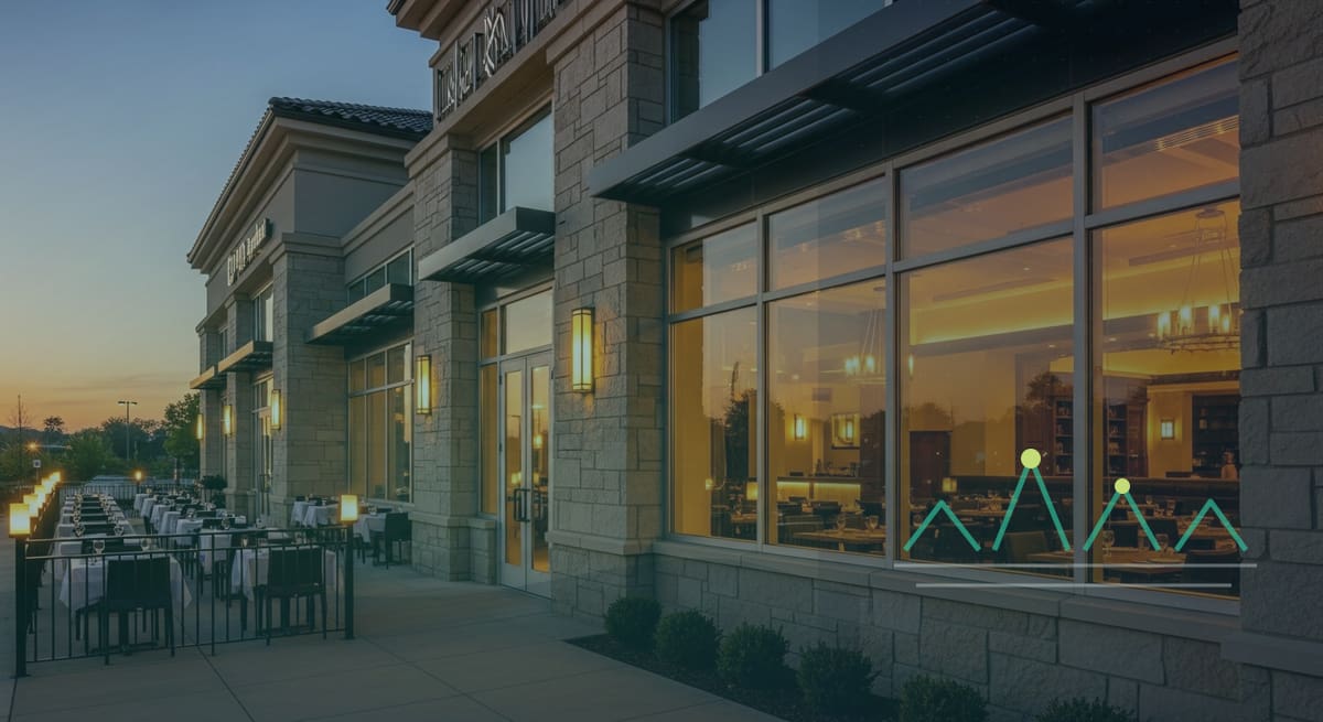 Restaurant building exterior with patio seating at evening